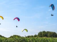 Longues-Sur-Mer, July 2019 Paragliders flying over Longues-Sur-Mer in Normandy, one of D-day landing beaches