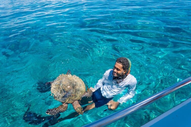 Man swimming with Turtle Seychelles Island Cocos Island