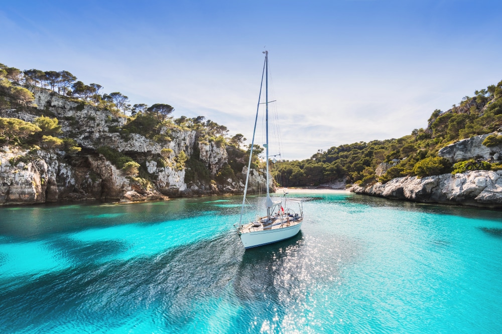 beautiful beach with sailing boat yacht Menorca Island Spain yachting