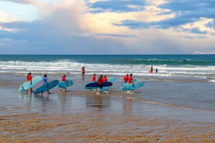 Groupe de surfeurs allant à l'eau, Biarritz, France