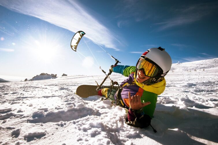 Snowboarder fait du snowkite à la montagne