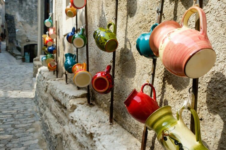 Multicolored ceramic jugs on display for street trade in Les Baux-de-Provence, artisan crafts