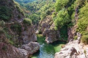 Swimmers enjoying the natural pool at Pont du Diable in Thueyts, Ardèche, France