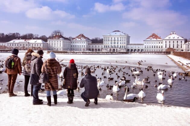 Nymphenburg Palace with visitors walking and relaxing in Munich, Germany