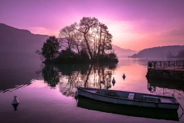 Lac d'Annecy gelé en hiver avec montagnes enneigées en arrière-plan, France