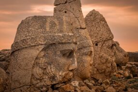 Ancient carved heads of Zeus, Apollo, and Hercules