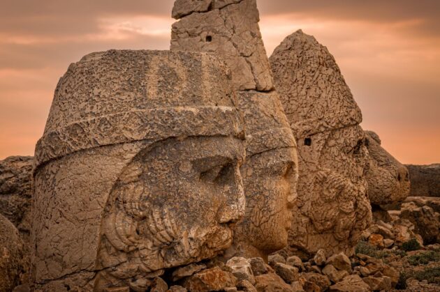 Ancient carved heads of Zeus, Apollo, and Hercules