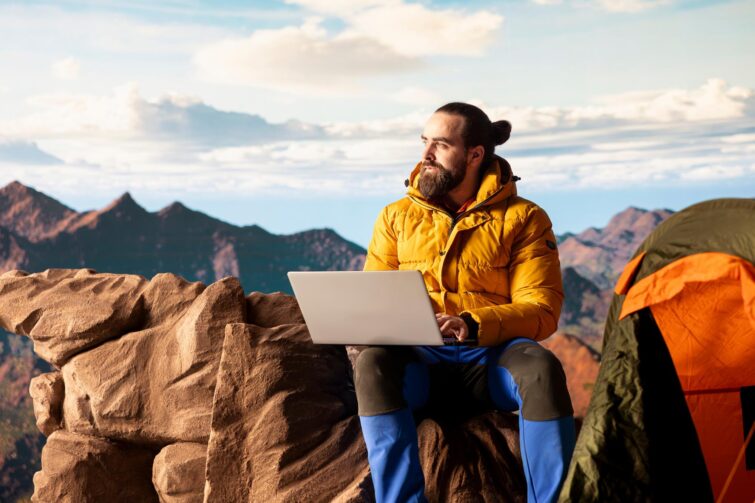 Jeune entrepreneur utilisant un ordinateur portable pour gérer l'empreinte carbone post-voyage