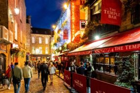 Temple Bar district bustling with people during a lively evening in Dublin, Ireland