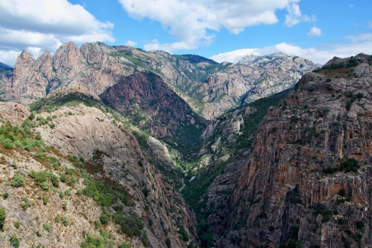 Vue panoramique sur les Gorges de Spelunca en Corse, montrant la route D84 et le paysage montagneux environnant
