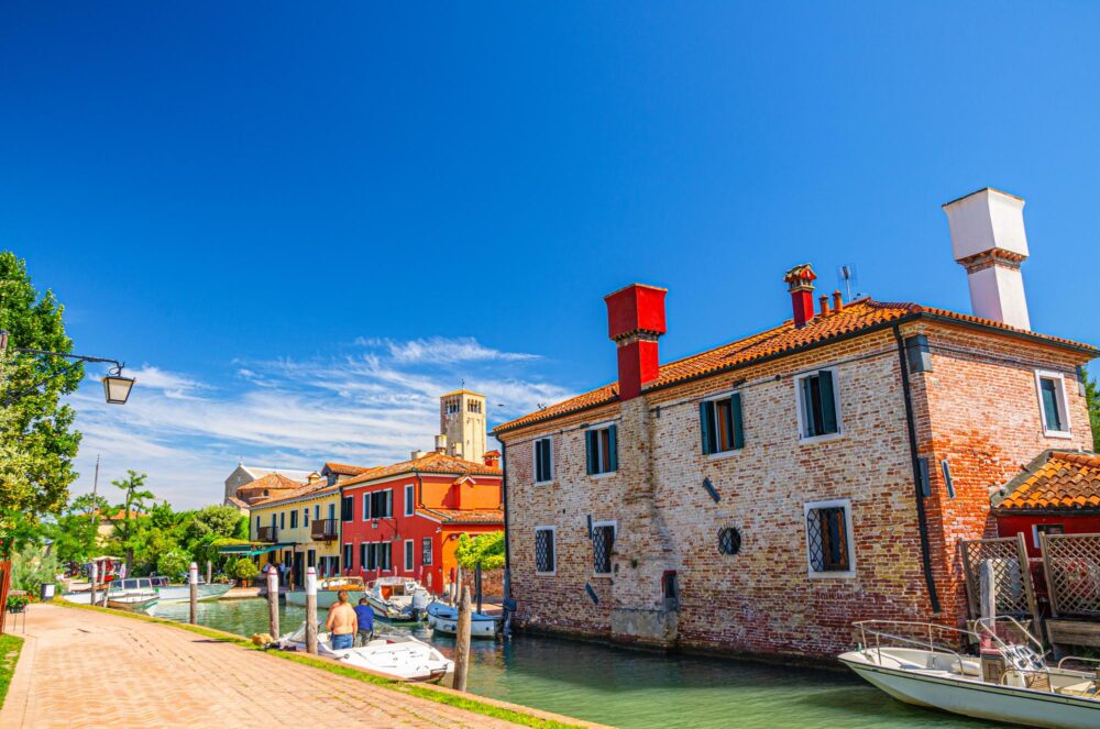 L'île de Torcello avec sa promenade le long du canal d'eau et des bâtiments colorés.