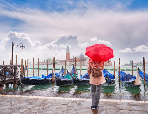 Femme visite Venise sous la pluie