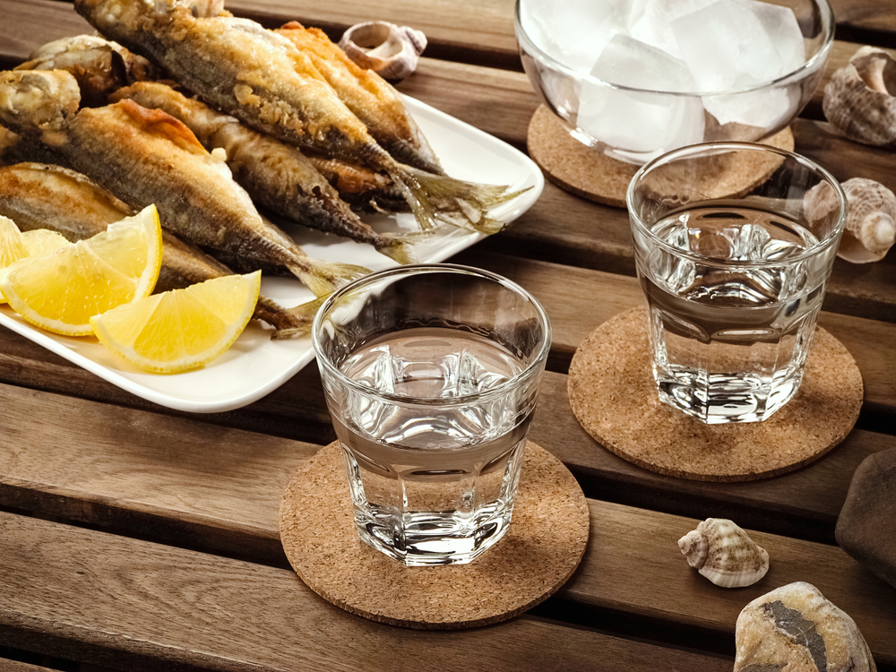 Deux verres de tsipouro accompagnés de poissons